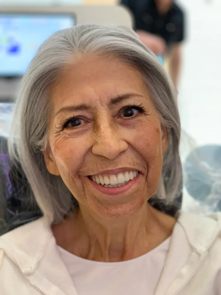 Patient smiling after dental implant treatment